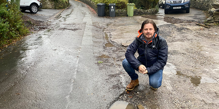 Mark Kenyon with one of the many potholes on Thornley Lane, Grotton